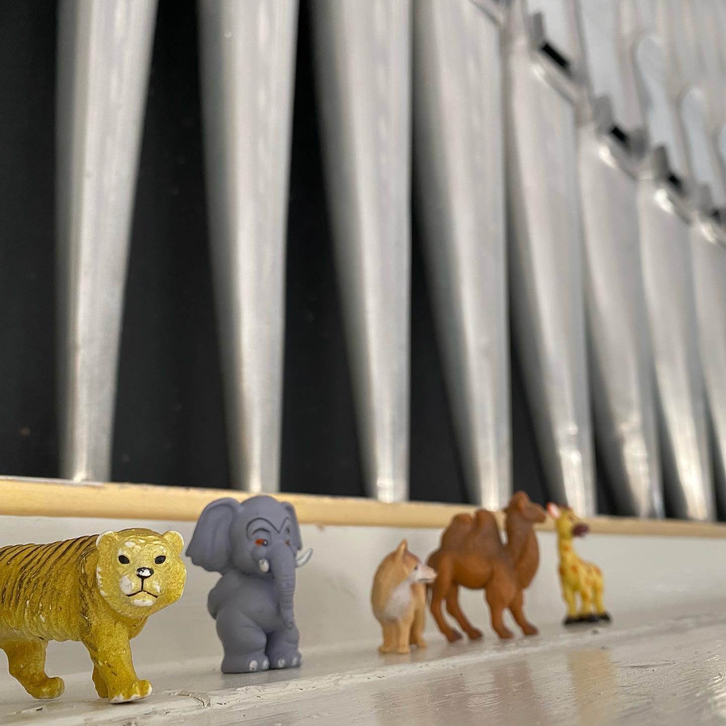 Framför orgelpiporna i Stala kyrka står ett antal små plastdjur på rad.