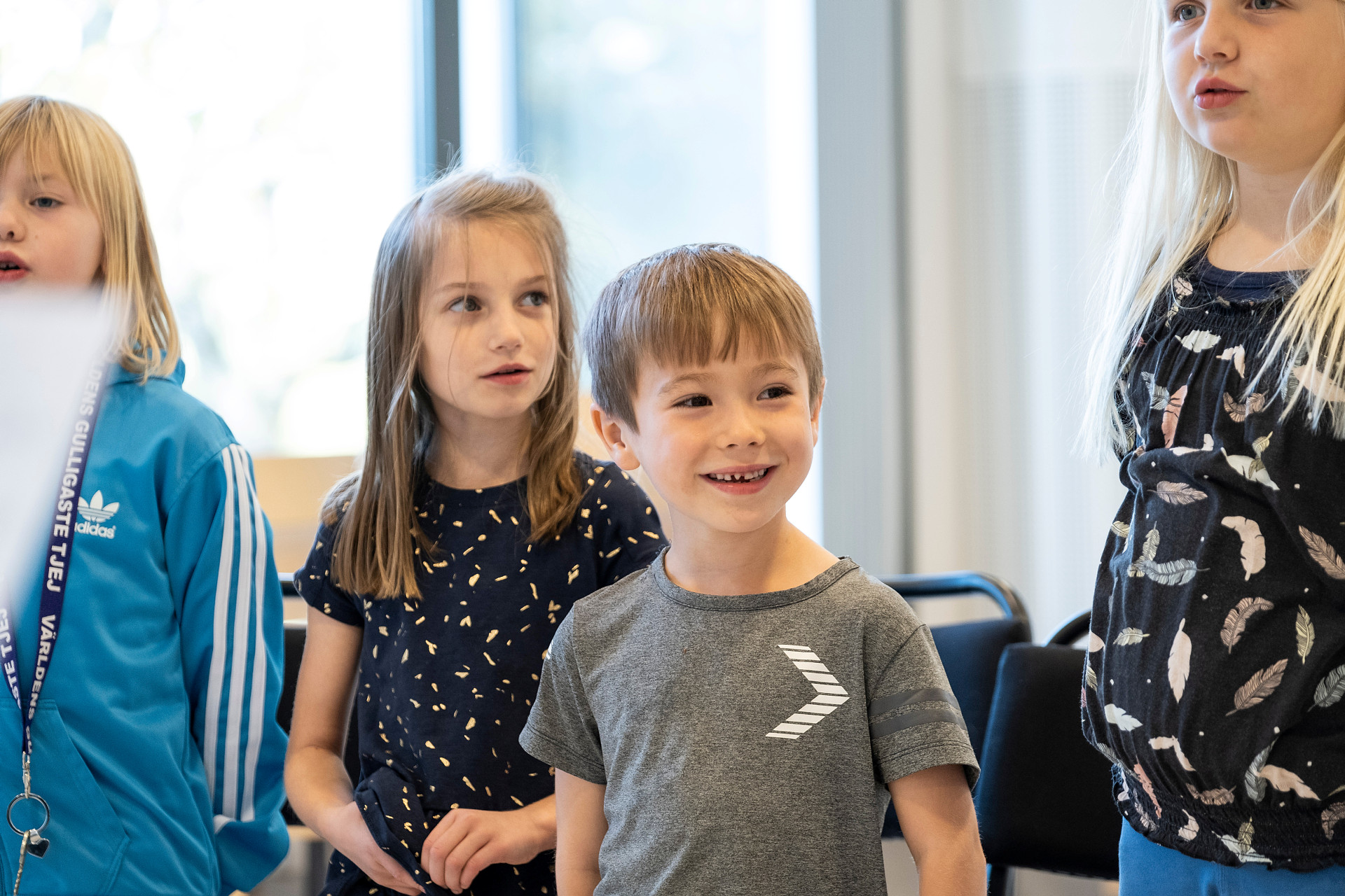 Fyra barn sjunger i en kör.