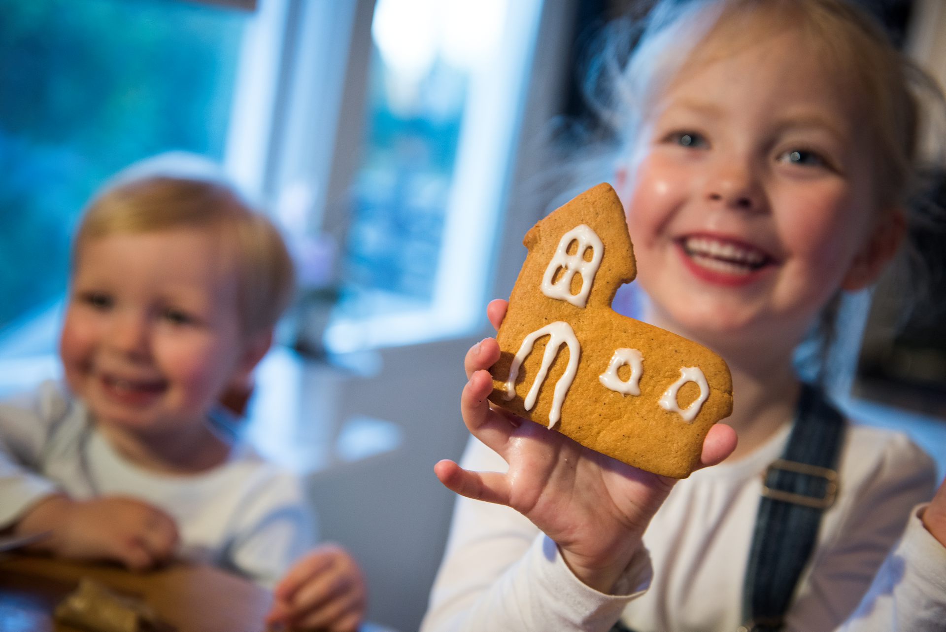 Glad flicka visar pepparkakskyrka